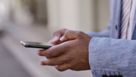 black man, hands and phone typing in the city