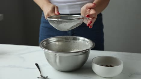 woman sifting flour for baking