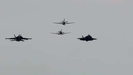 three fighter jets perform a synchronized aerial formation against a cloudy sky, showcasing precision flying at the avalon airshow