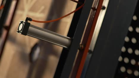 closeup of a woodworker operating industrial machinery during manufacturing of wood furniture