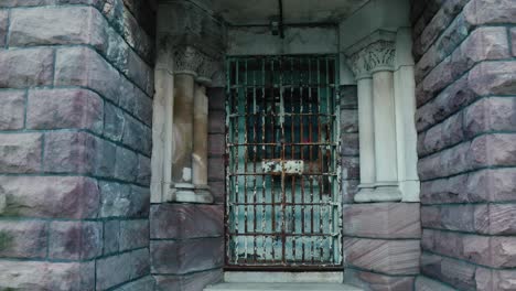 looking at an old prison or castle doors of a limestone brick structure buidling