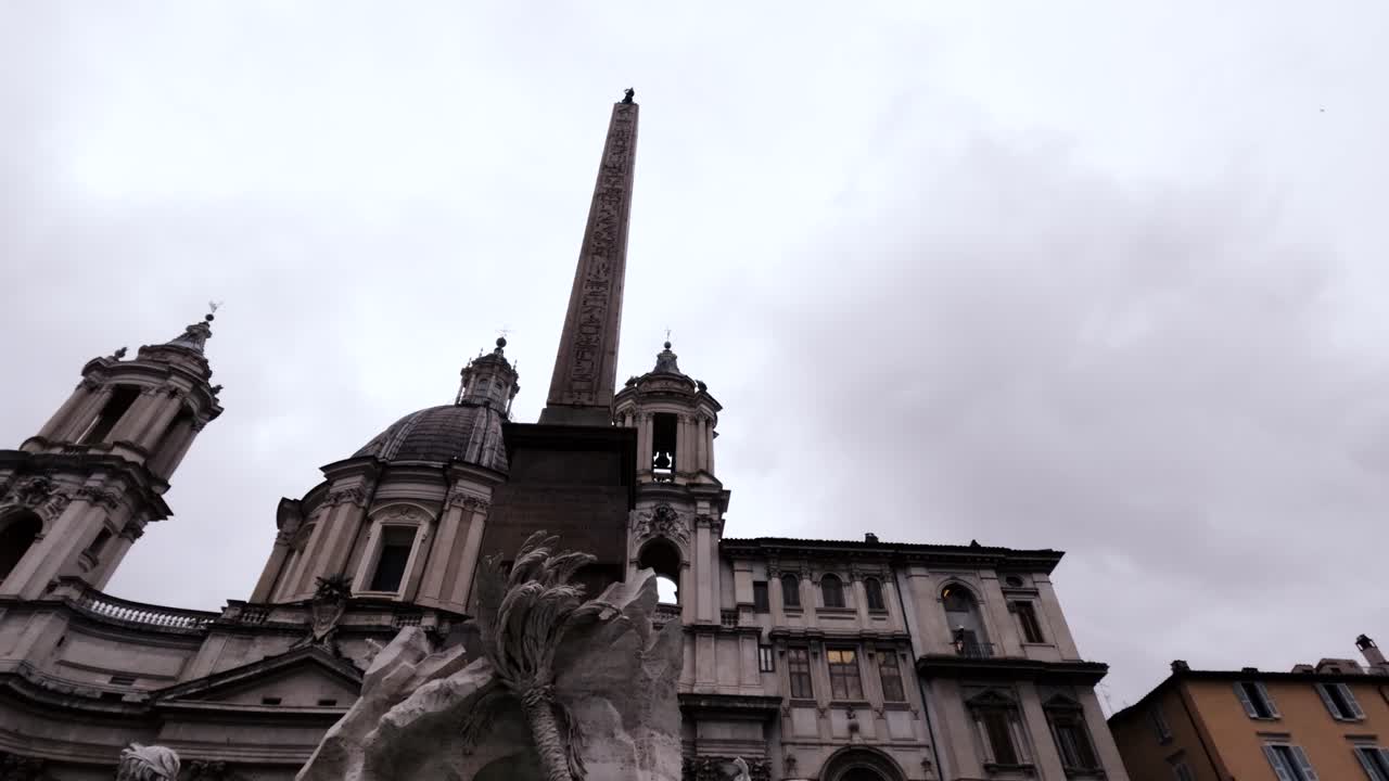 A View Of Fontana dei Quattro Fiumi Fountain In The Piazza Navona In Rome, Italy. Low Angle Shot