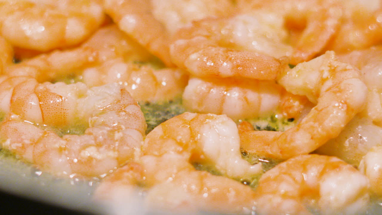 Static Shot of King Prawns Cooking in Bubbling Oil in Pan. Slow Motion Close Up Details of Tasty Shellfish Seafood