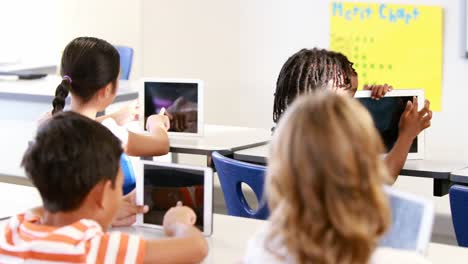 school kids studying in classroom