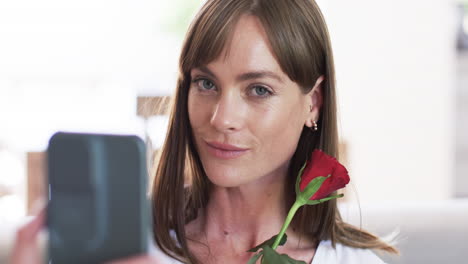 middle-aged caucasian woman poses for a selfie at home