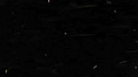 abstract black background with light streaks and particles