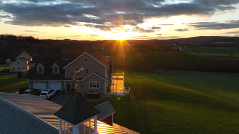 colorful starburst sunset with bald eagle rooftop ornament. rural countryside view in america. usa theme nature meadow pasture valley view.