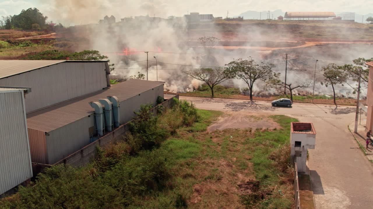 Smoke from a fire near buildings and trees