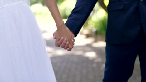 wedding, marriage and couple holding hands in park