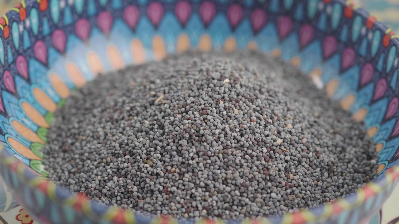 Close-up of Poppy Seeds in a Vibrant Patterned Bowl