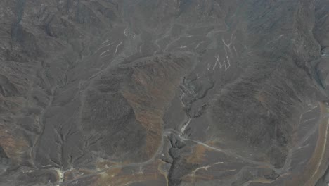 aerial bird's eye view of a mountain revealing the sunrise