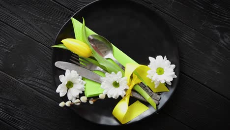 easter spring table dishware composition with yellow tulip flower