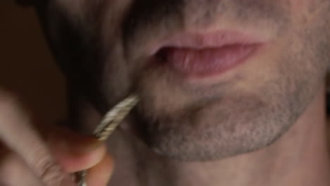 a man taking a bite from some psychedelic mushrooms, extreme close up