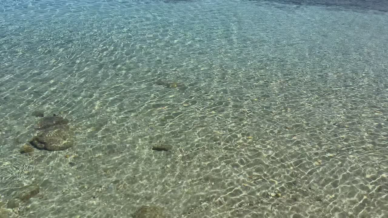 Stunning beach scene in Halkidiki, Greece, with elegant sunbeds facing the crystal-clear turquoise sea. A perfect summer escape in the heart of the Aegean.
