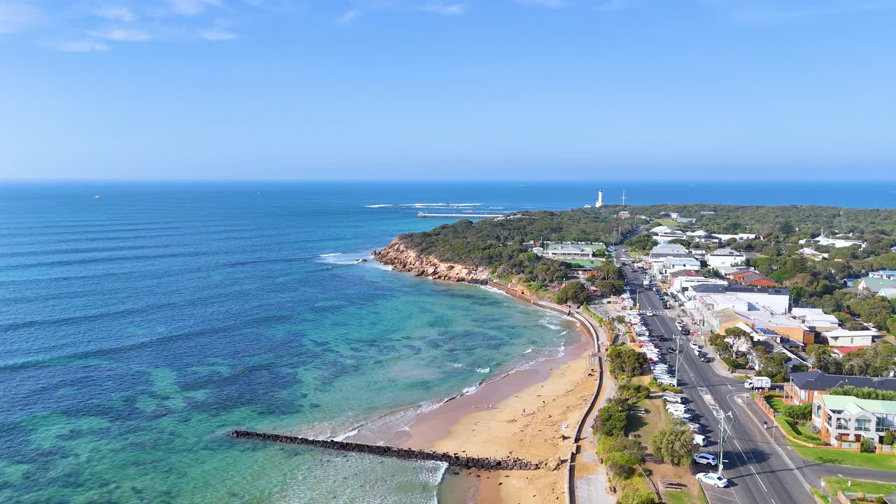 Aerial footage captures the scenic coastline of Point Lonsdale, Australia, showcasing clear skies and vibrant ocean hues