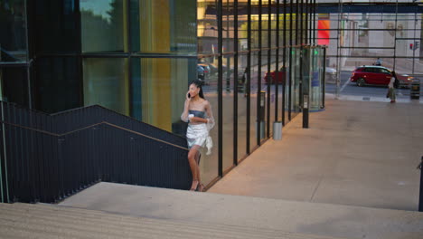 fashion brunette calling phone walking urban downtown. woman talking cellphone