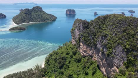 towering mountain with islands, and coral reef, krabi, thailand