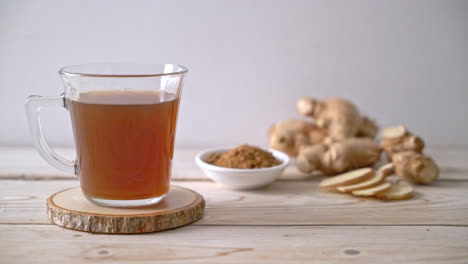 hot and sweet ginger juice glass with ginger roots - healthy drink style