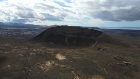 panoramic drone ascends to establish calderon hondo volcano in fuerteventura