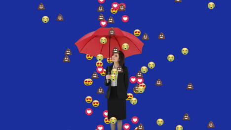 이모티콘이 파란색 배경에 우산을 들고 있는 사업가에게 떨어지고 있습니다.