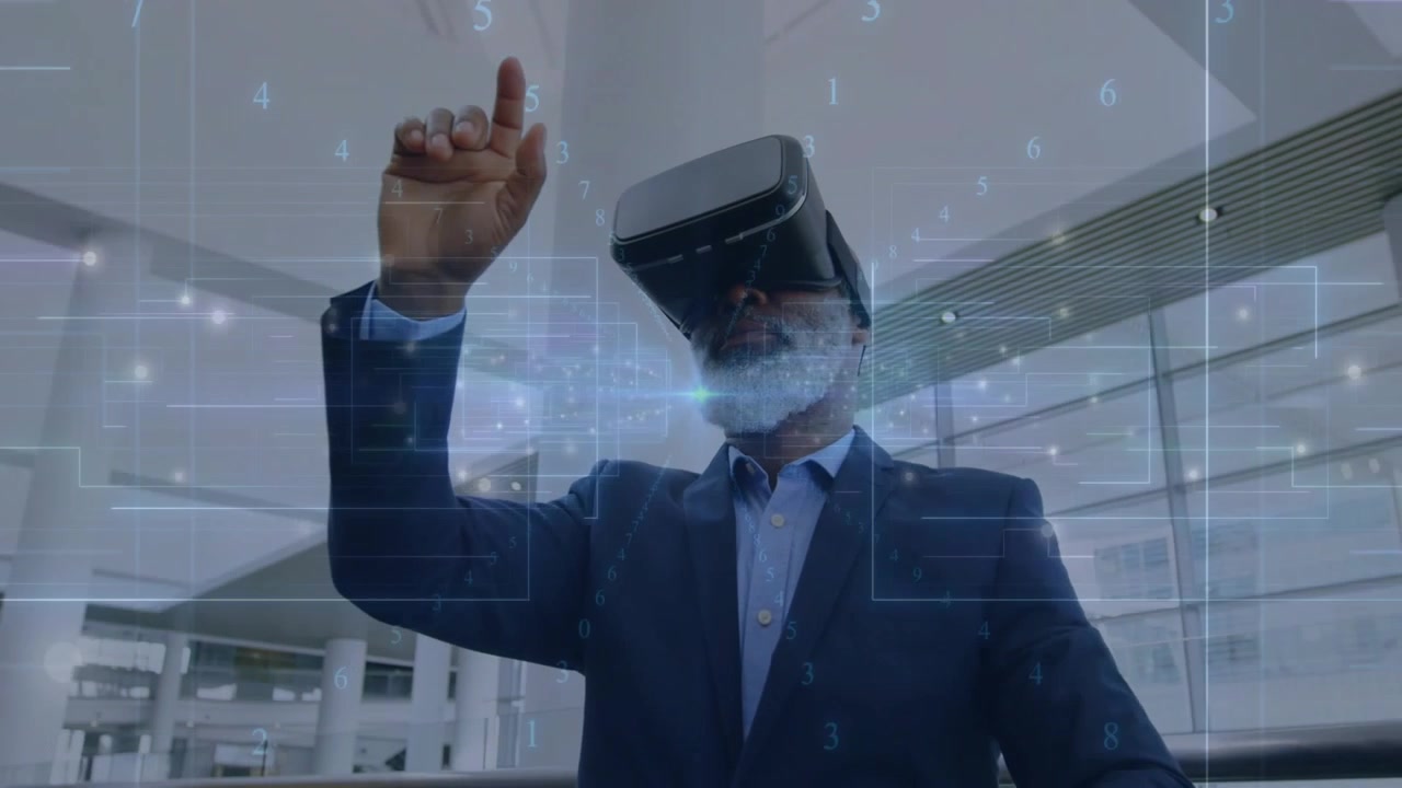 Senior executive in atrium raising hand, wearing VR and manipulating hologram business analytics