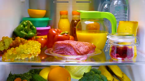 Fresh-raw-meat-on-a-shelf-open-refrigerator