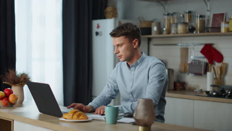 manager start online meeting sitting at home kitchen. man making video call.