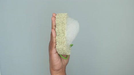 hand holding a bath sponge with soap foam