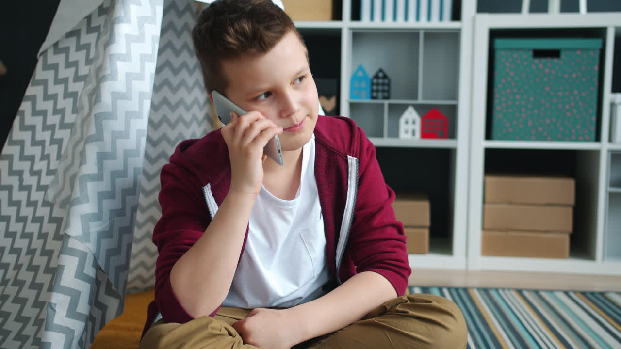Boy Talking on Phone in a Play Tent