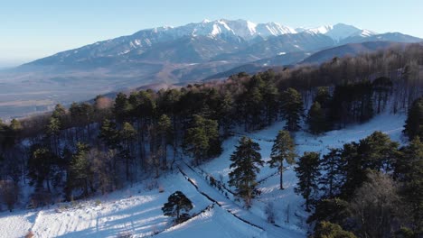 Aerial-Drone-shot-Mount-Olympus-forest-foreground-winter-snow-panning-left