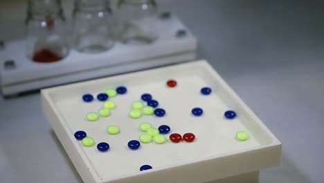 laboratory experiment with colored pills and lab supplies