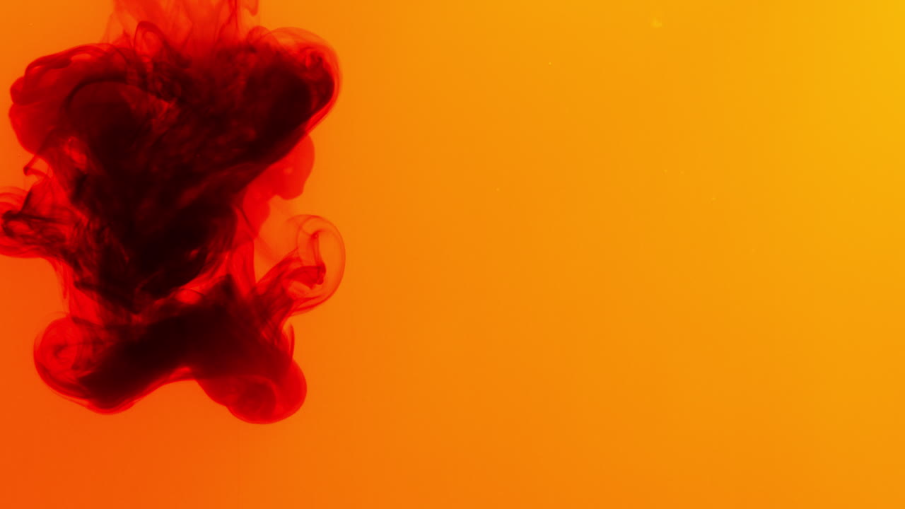 Red And Yellow Paint Or Dye Dropped Into Water Against White Background To Create Swirling Colourful Smoke Background 4
