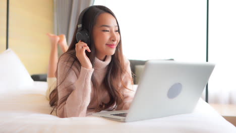 happy asian enjoying quarantine time listening to music