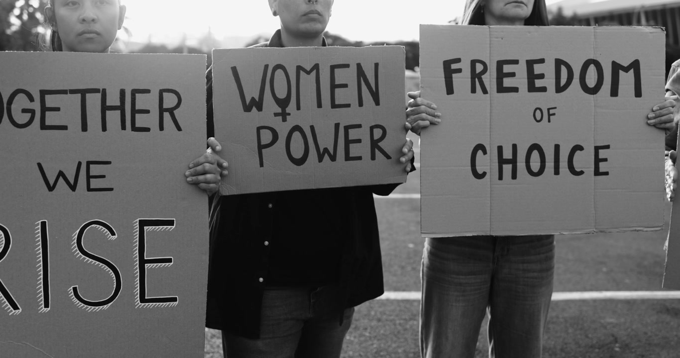 Women Holding Protest Signs for Freedom and Empowerment