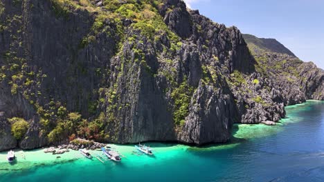 scenic view of the stunning talisay beach, with boats at tapiutan island, philippines