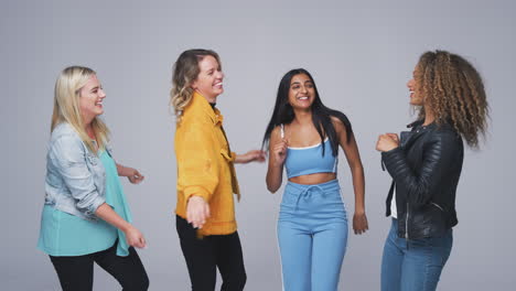 fotografía de grupo de jóvenes amigas multiculturales bailando juntas en cámara lenta