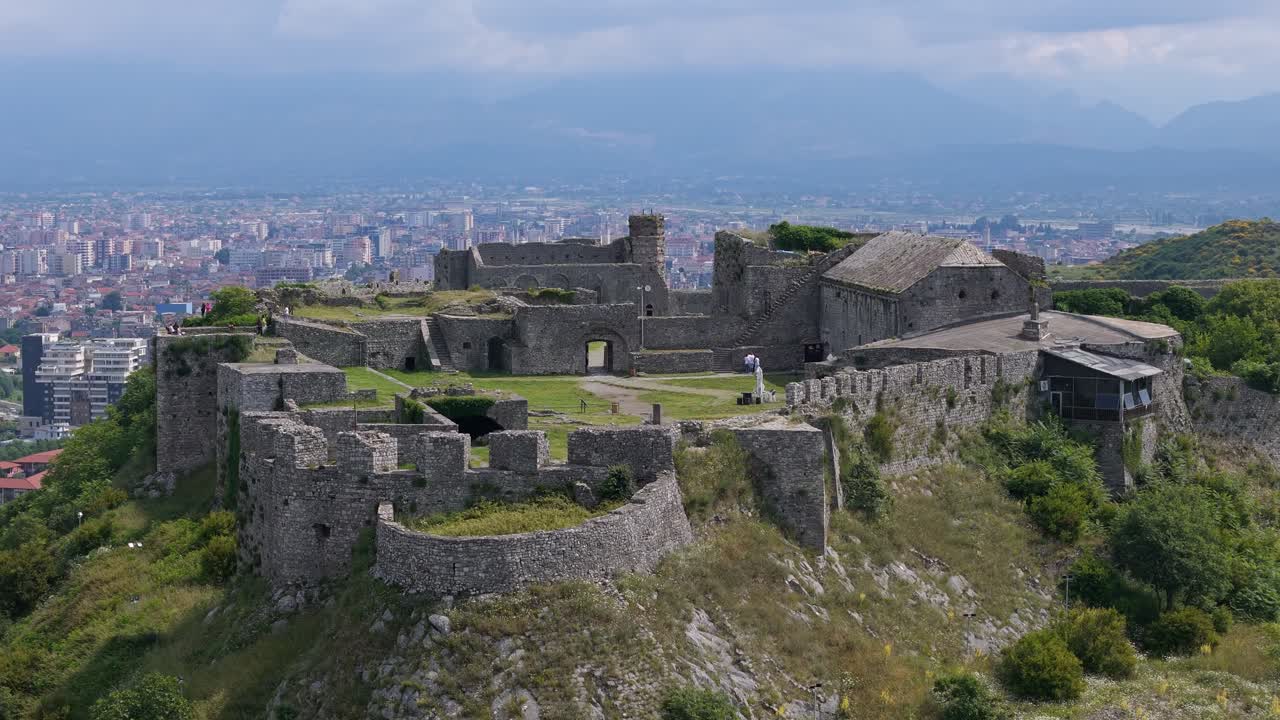 Ruins of Rozafa Castle in Albania. Drone over historical building reveal cityscape of Shkoder on horizon.