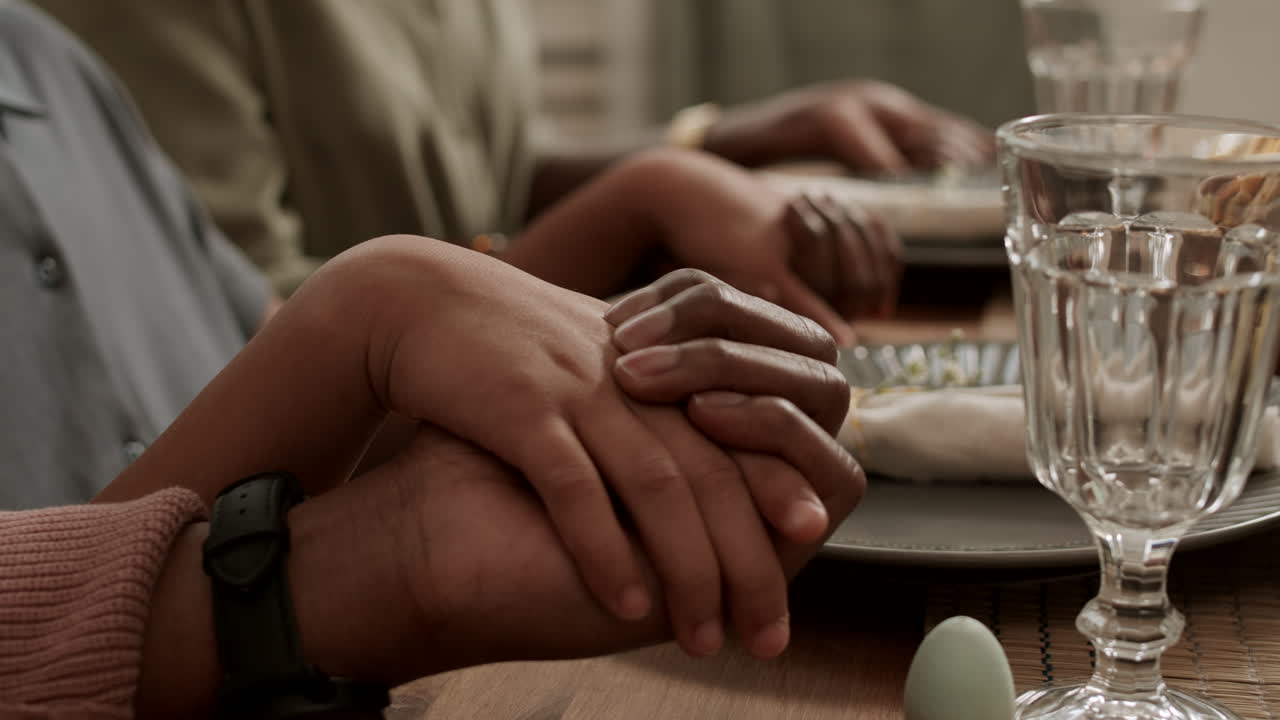 Holding Hands Praying Before Dinner