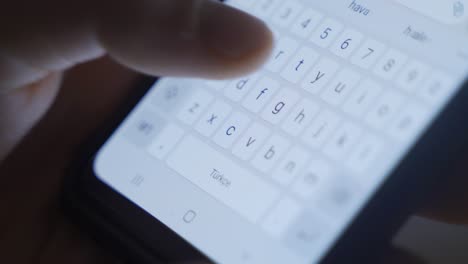 typing a message from the close-up phone keyboard.