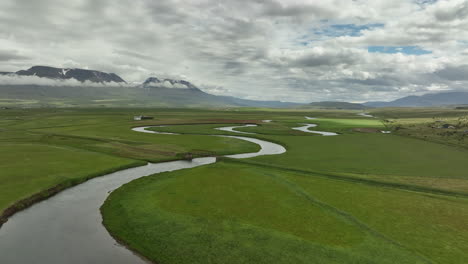 old bridge over a river in green pasture iceland aerial