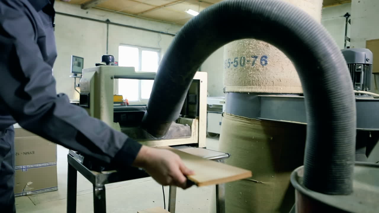 Carpenter workplace. Man using saw to cut wood