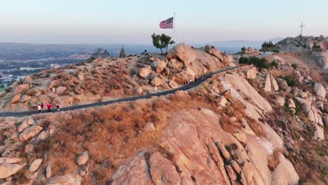 mt-rubidoux-in-riverside-california-at-sunset-with-people-hiking-in-view---AERIAL-TRUCKING-PAN