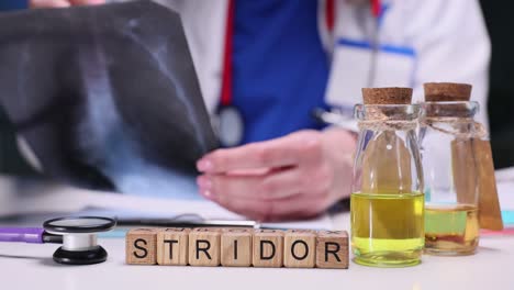a doctor's desk with medical equipment and the word 'stridor' spelled out
