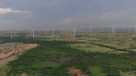 an aerial shot of wind turbines with beautiful blue sky, zorlu energy wind turbines installed in jhimpir near gharo sindhi pakistan