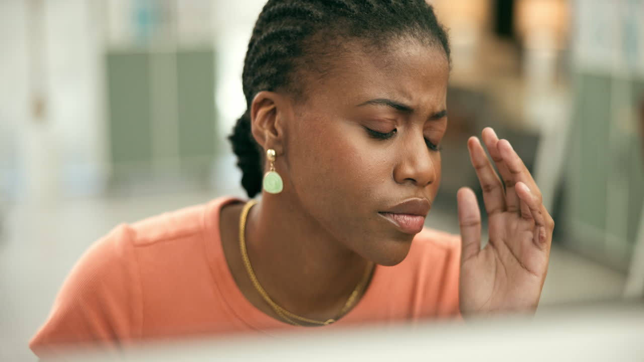 Woman Experiencing Headache in Office