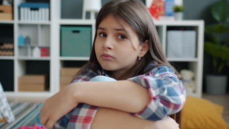 a thoughtful girl sitting on the floor