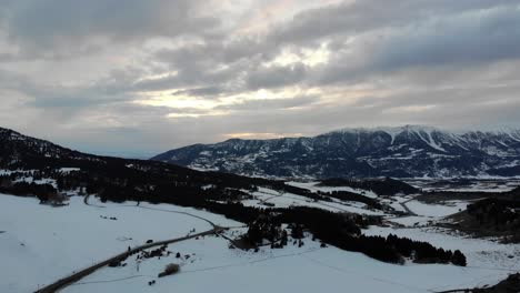 Drone-shot-of-magnificent-snowy-mountains-during-winter