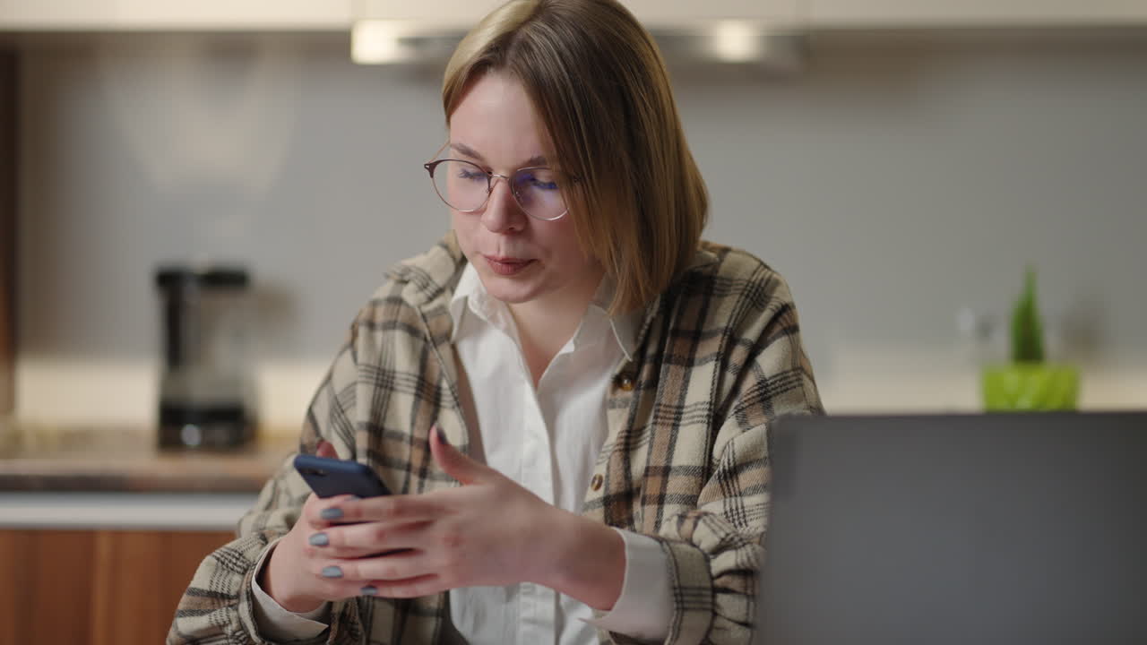 Portrait of happy business woman enjoy success on mobile phone at home office. Closeup joyful girl reading good news on phone in slow motion