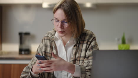 portrait of happy business woman enjoy success on mobile phone at home office. closeup joyful girl reading good news on phone in slow motion