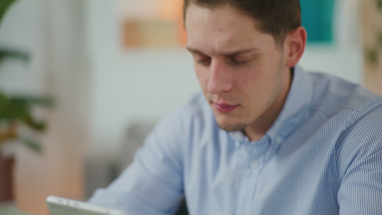 Sad Man Works on Digital Tablet